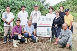 説明板を設置した多良間郷友会と文化財課のメンバーたち＝15日、石垣市北部（石垣市教育委員会文化財課提供）